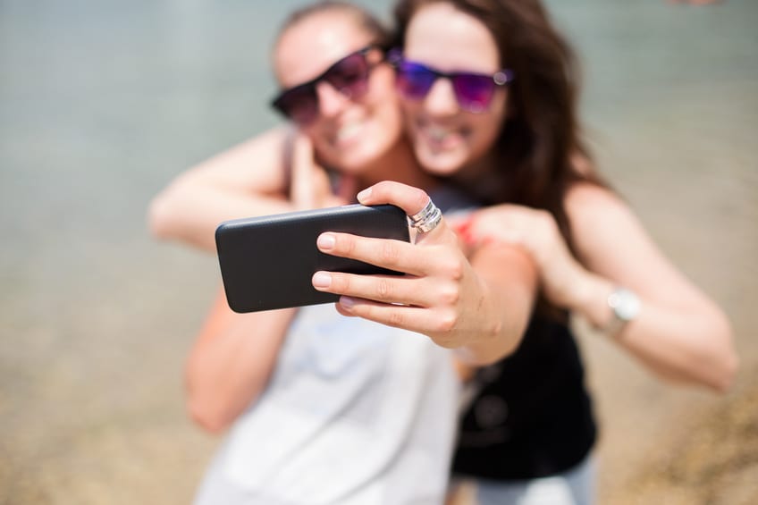 Summer vacations – Girls taking selfie on the beach