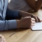 Close,Up,Of,Man,Hand,Holding,Ballpoint,And,Signing,Legal